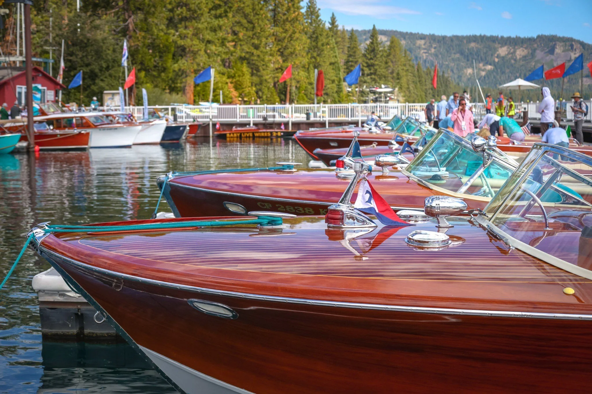 Classic wooden boats lined along the docks at the Lake Tahoe Concours d’Elegance in Homewood.