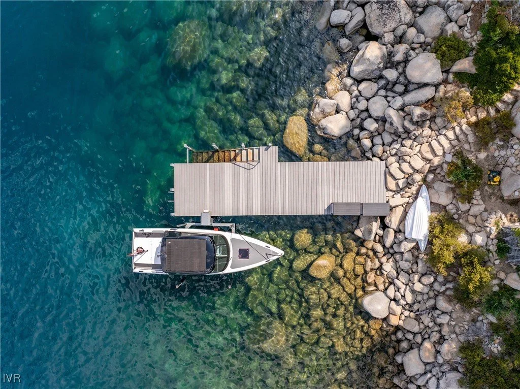 Aerial view of pier, boat, and rocky shoreline at 580 Gonowabie Rd in Crystal Bay, per the listing.