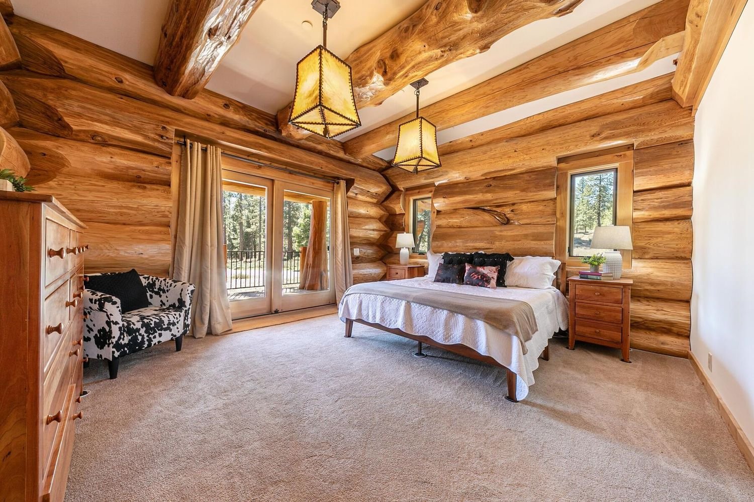 Bedroom with log wall and beam details at 12804 Quail Ln in Truckee, per the listing.