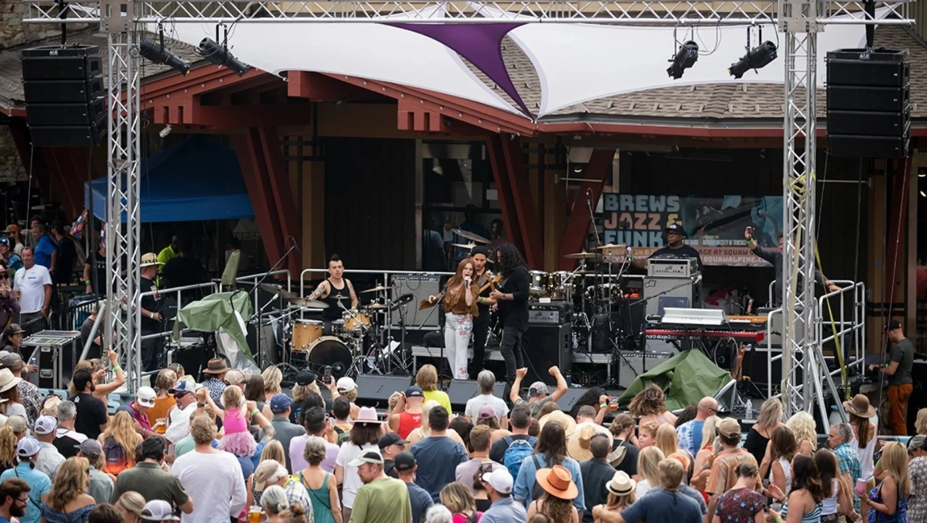 Crowd gathered outdoors in The Village at Palisades Tahoe during Brews, Jazz & Funk.