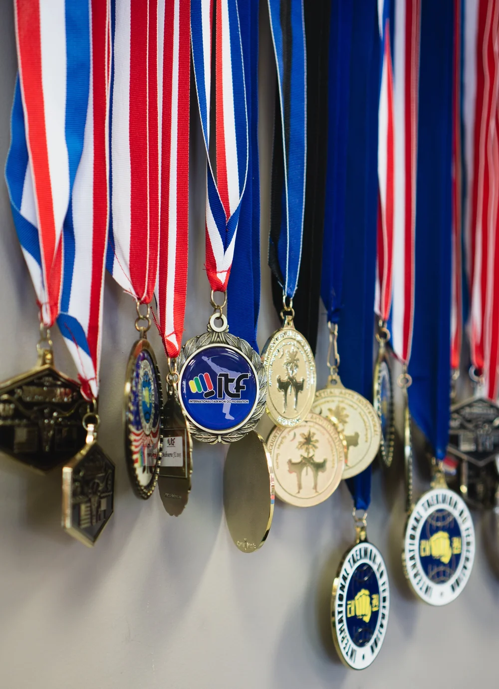 A wall of tournament medals earned by Titus Taekwon-Do Institute students