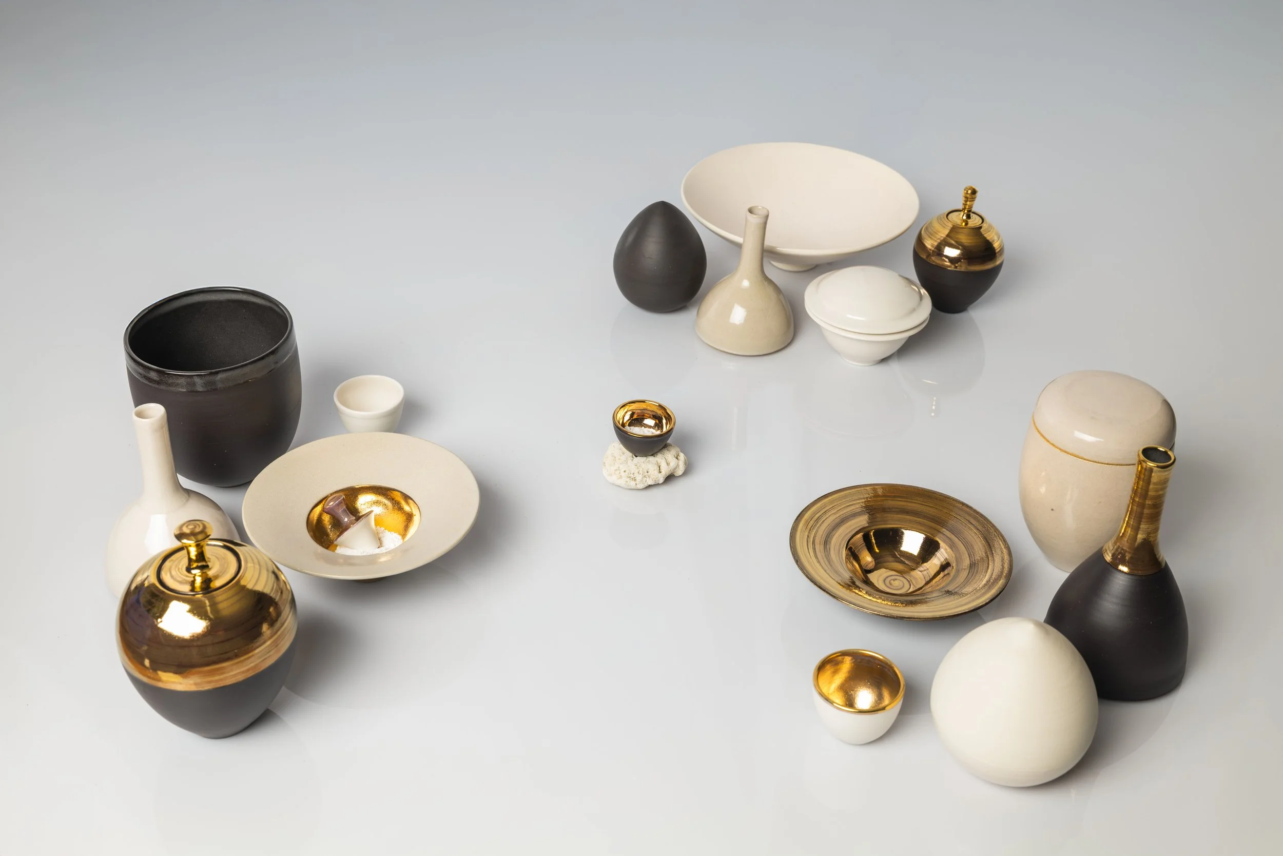 Phil	Greed "Calx_what goes around, comes around" 

Ceramics - wheel thrown ceramics, satin white midfire glaze, gold lustre, coral

16cm x 76cm $2,400
