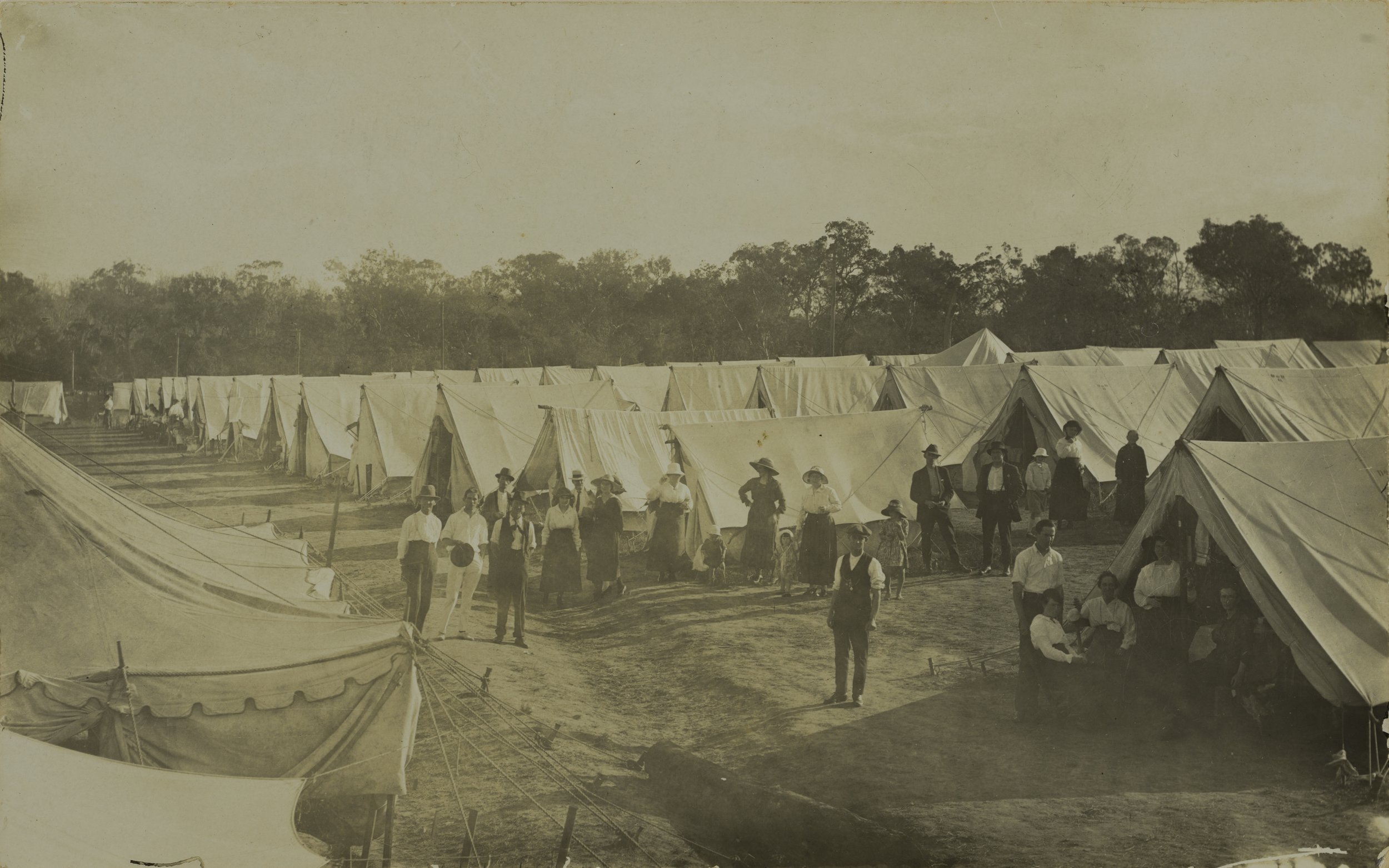 Groups of people standing around rows of tents at the Wallangarra Quarantine camp, May 1919 SLQ.jpg
