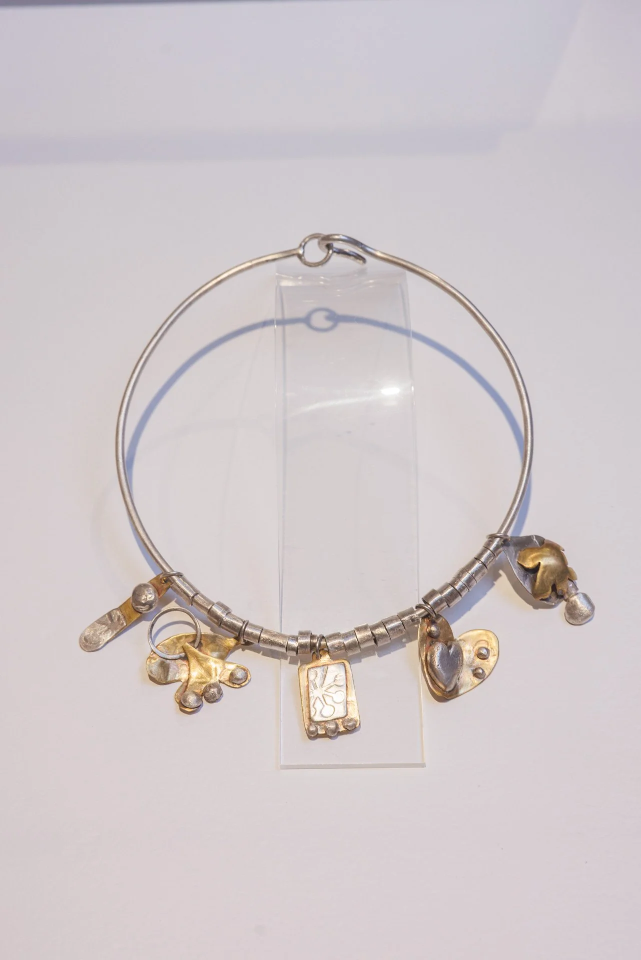Lisa Ashcroft "Gumnut and Wattle Talisman Torque"

Sterling silver and brass	

17cm x	17cm	$1,500

