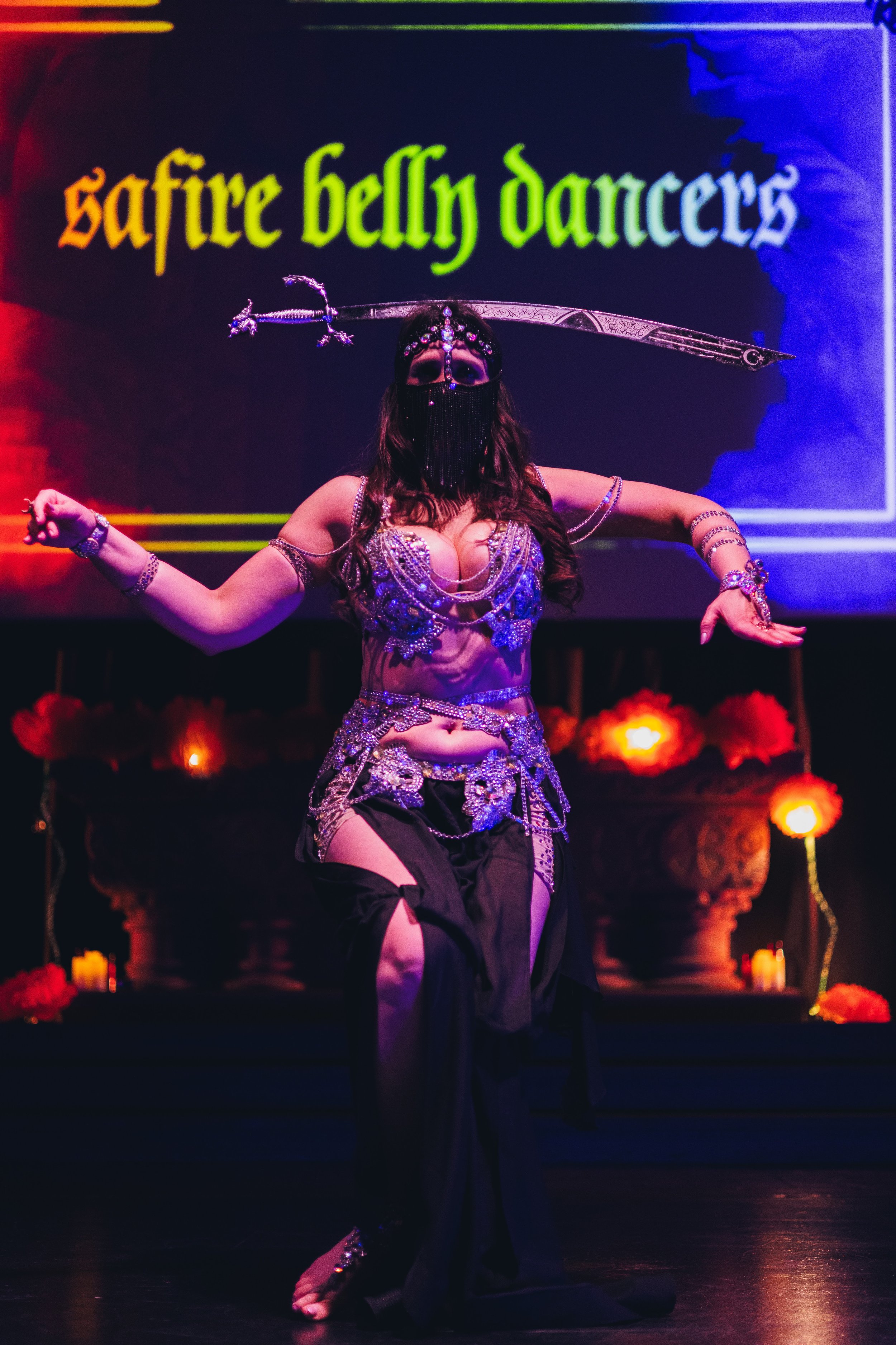 Belly Dancer Vanessa Oliveira dancing while balancing a Turkish sword on her head