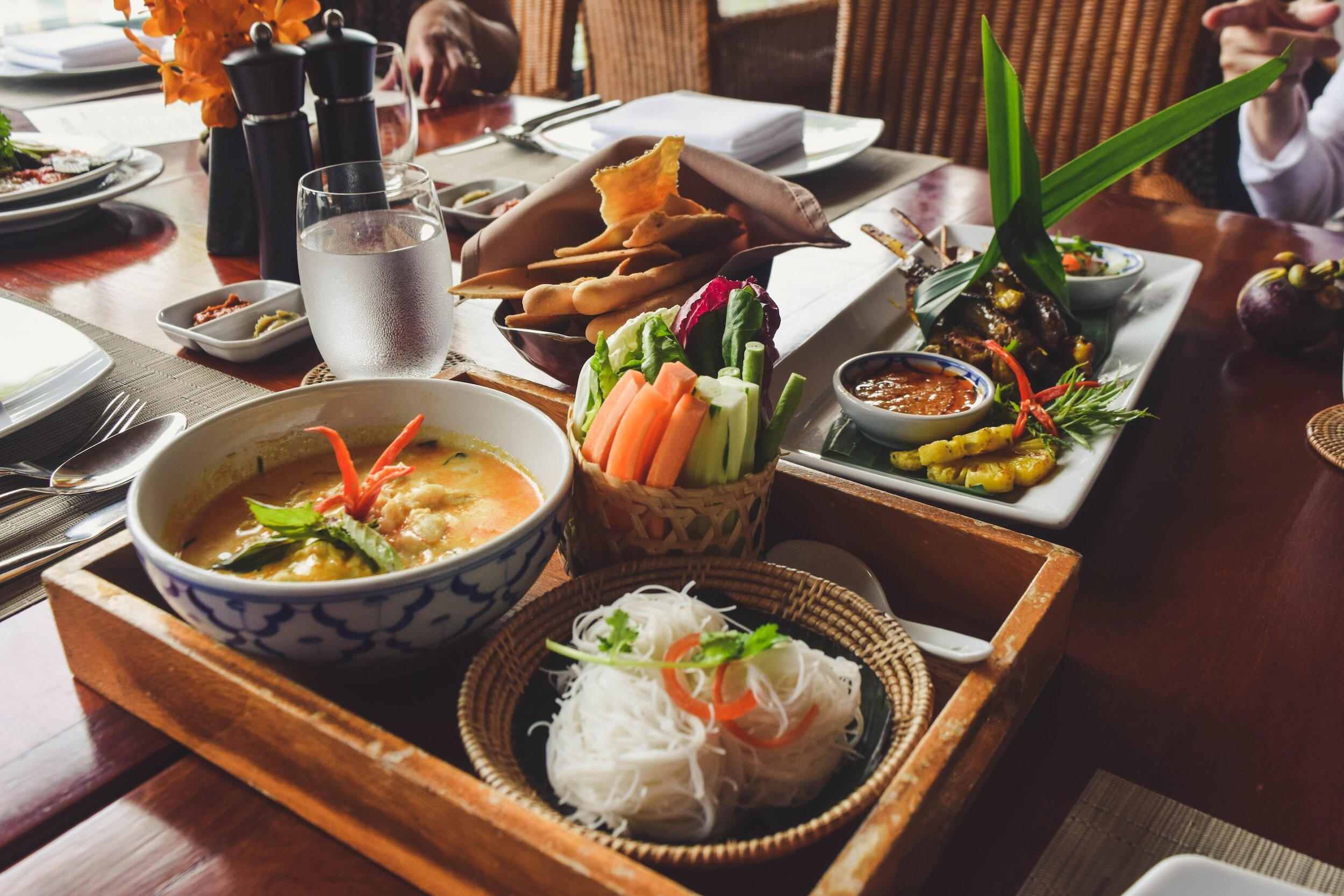 A selection of Thai delicacies, including a soup that balances sweet, sour and savoury, sate and more
