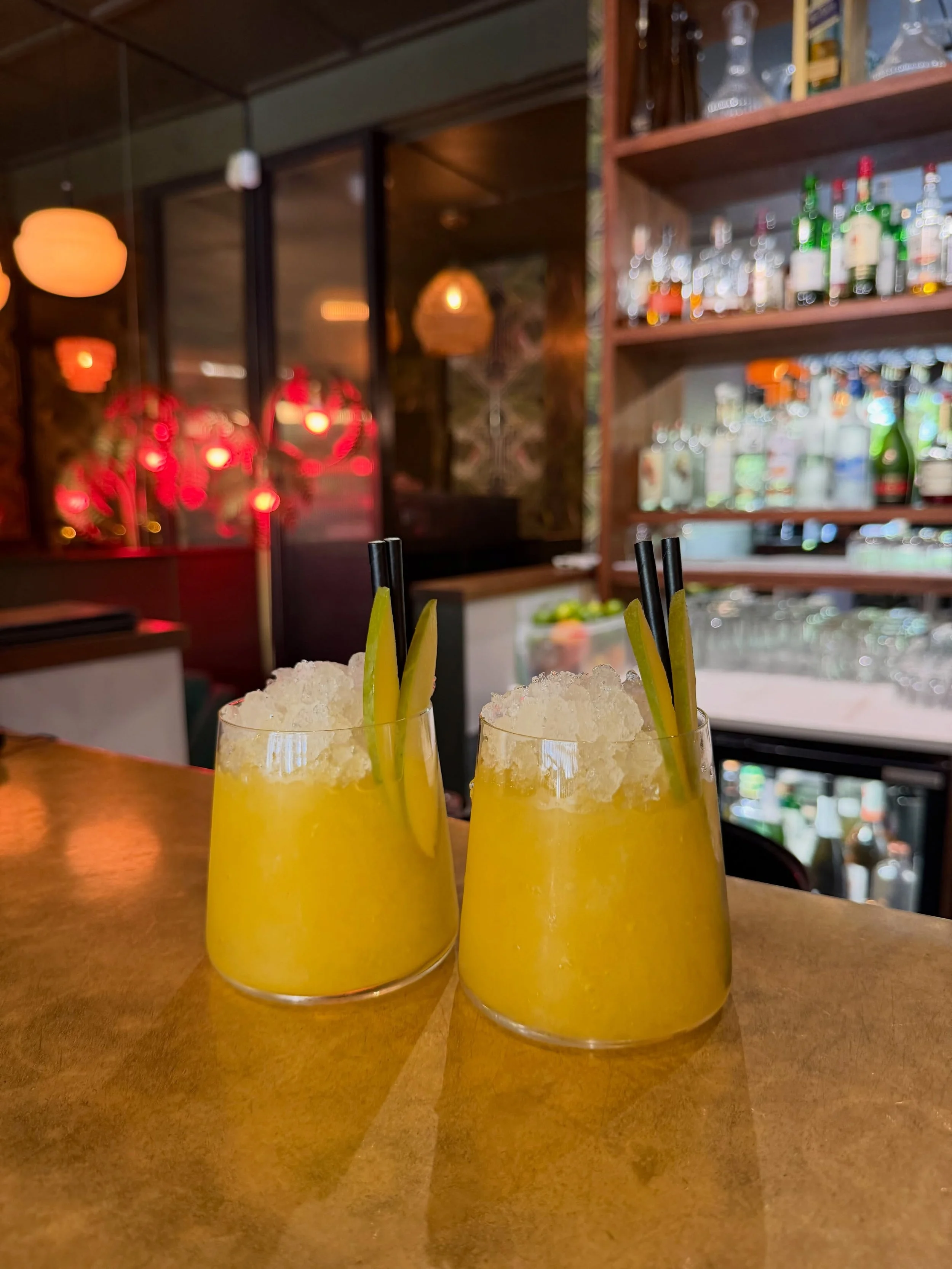 Two yellow cocktails with crushed ice at the Branded Beckenham bar.