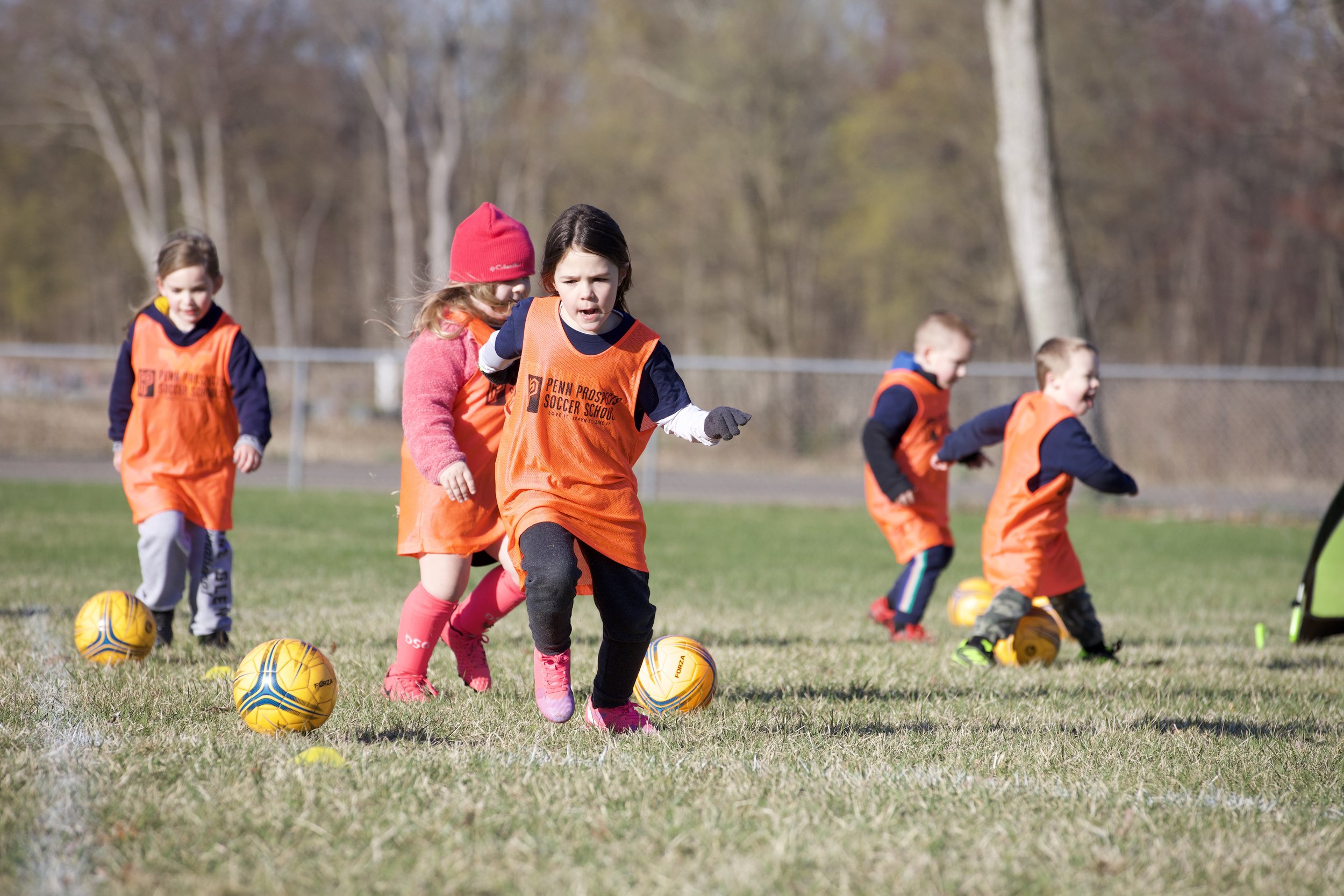Young Soccer Player having fun dribbling soccer balls.