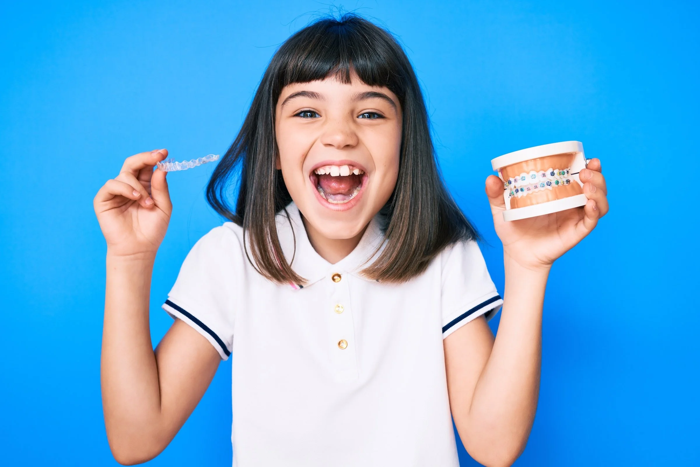 Girl smiling with braces.