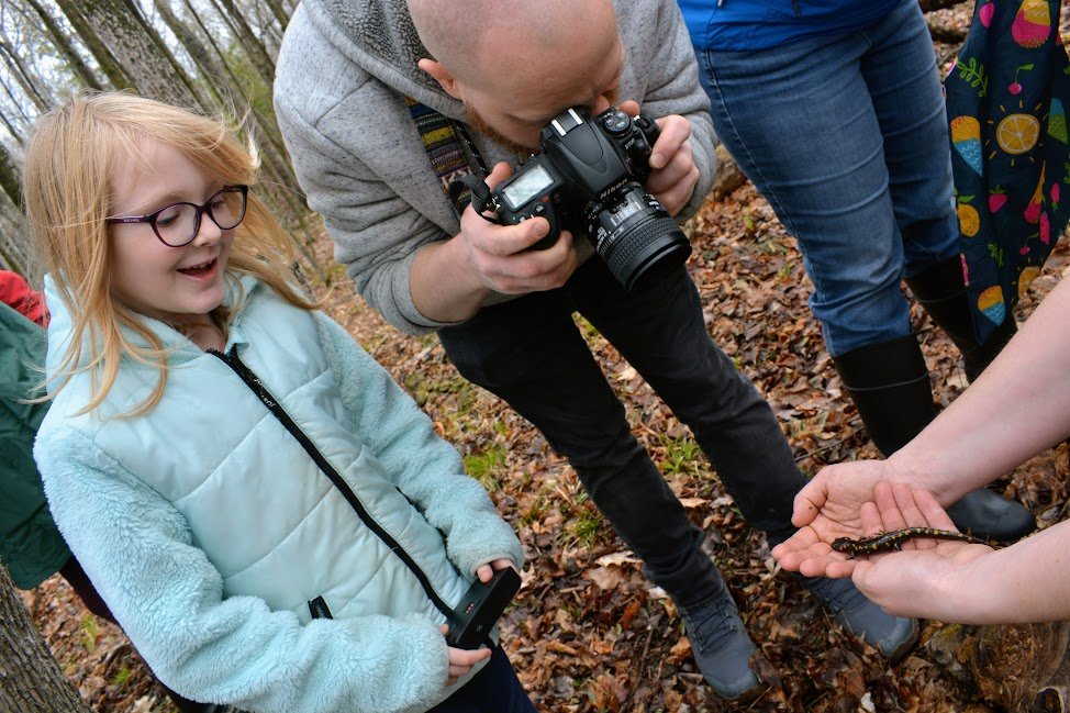  June Baer, 8, and her dad, Sam, check out a large spotted salamander. 
