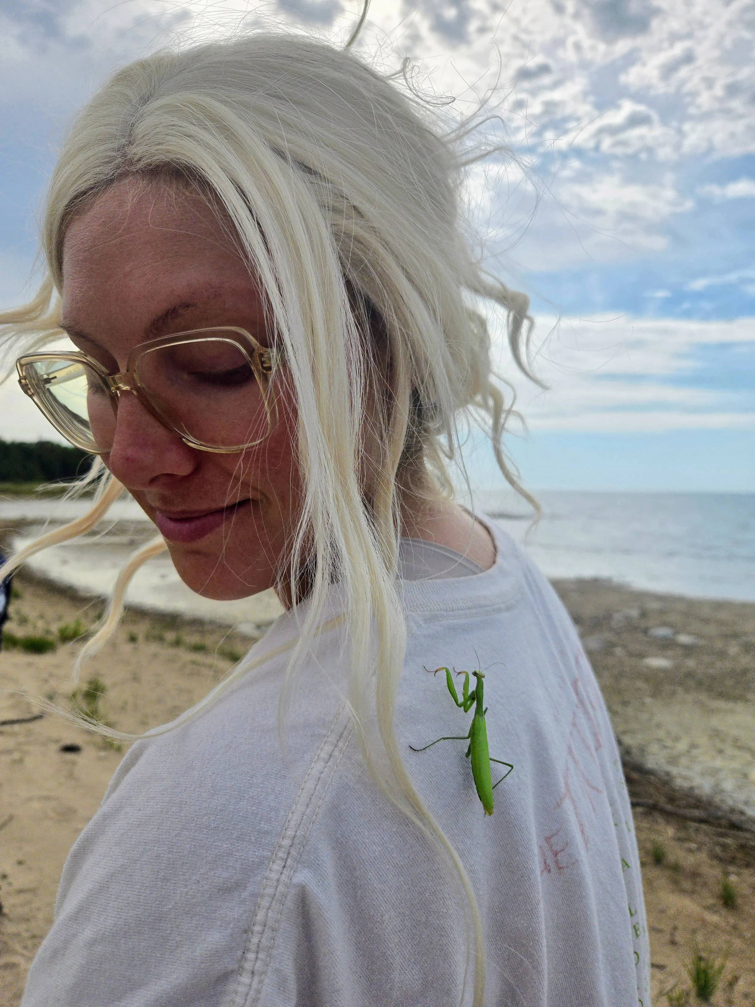  Laura Kraydich eyes a praying mantis which landed on her shoulder during North Point Exploration Day. 