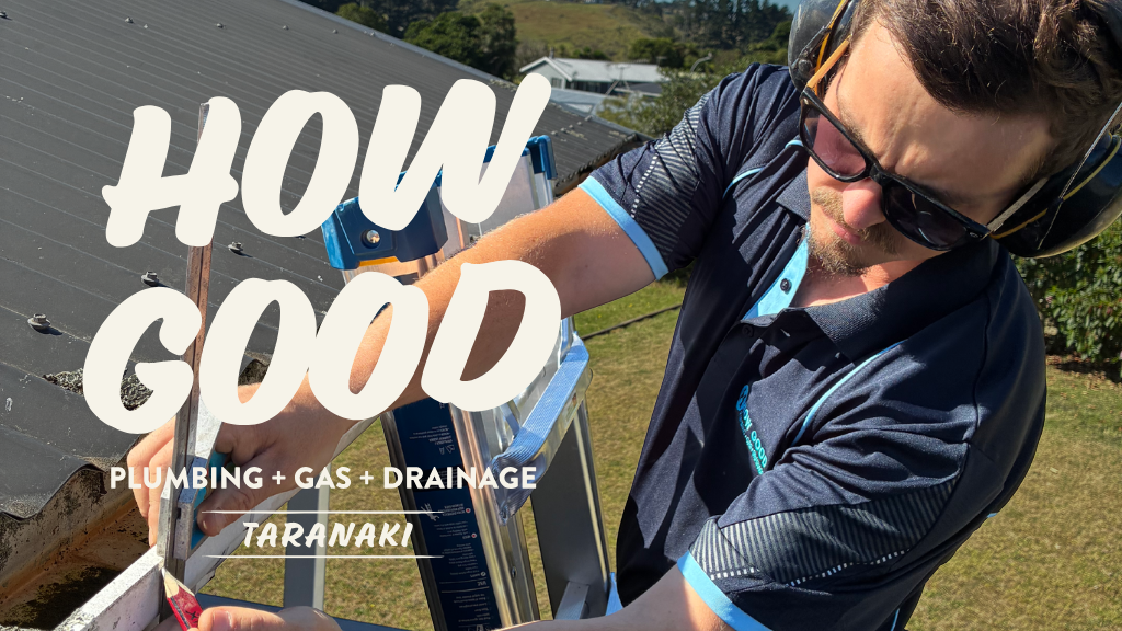 A man inspecting a roof with roofing tools, wearing safety glasses and a helmet, under a sunny sky, with the text 'How Good Plumbing + Gas + Drainage Taranaki' overlayed.