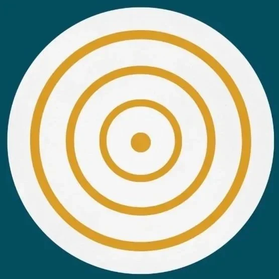 The image is an icon with two overlapping circles, there is an eye shape in the center semicircle. , the icon is yellow with a white background.