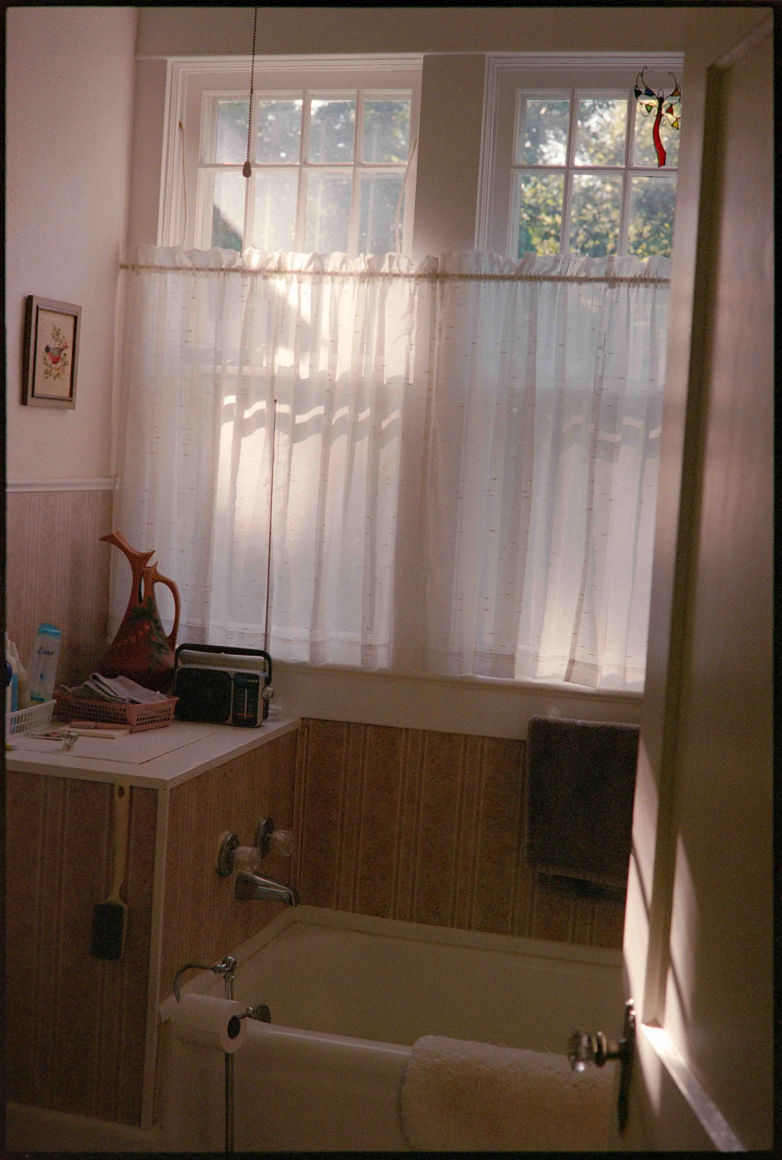 Documentary photo of a vintage pink bathroom shot on 35mm film