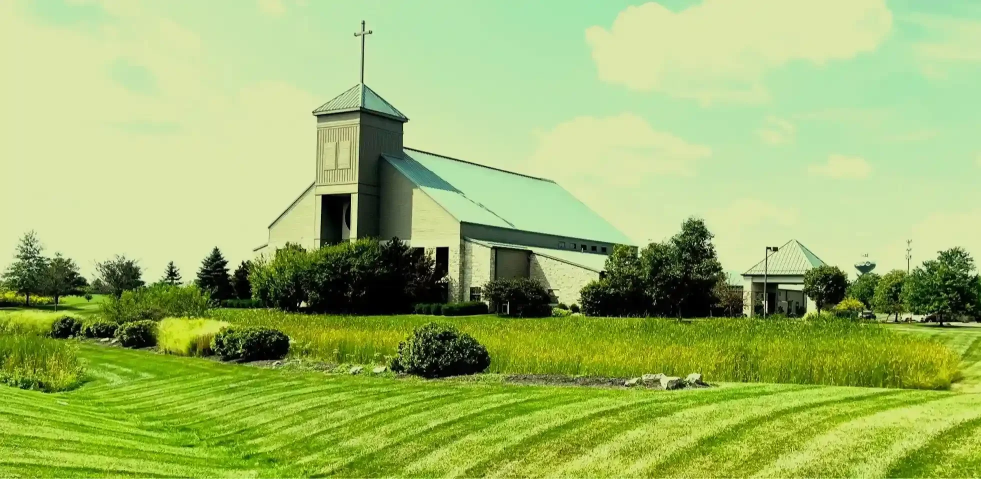 Professionally mowed lawn in front of a church in the background.