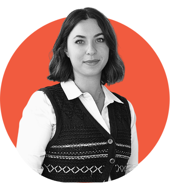 Black and white portrait of a young woman with shoulder-length wavy hair, wearing a white collared shirt and a dark knitted vest, set against an orange circular background.