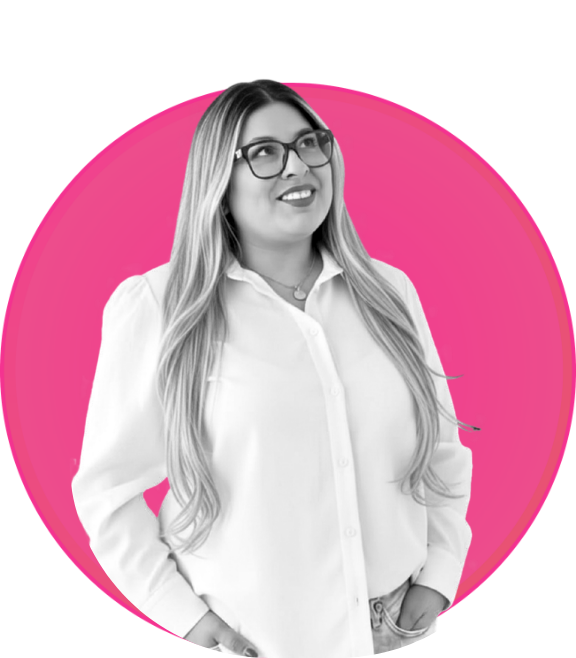 A woman with long, wavy hair wearing glasses and a white button-up shirt, smiling and looking to the side, in front of a pink circular background.