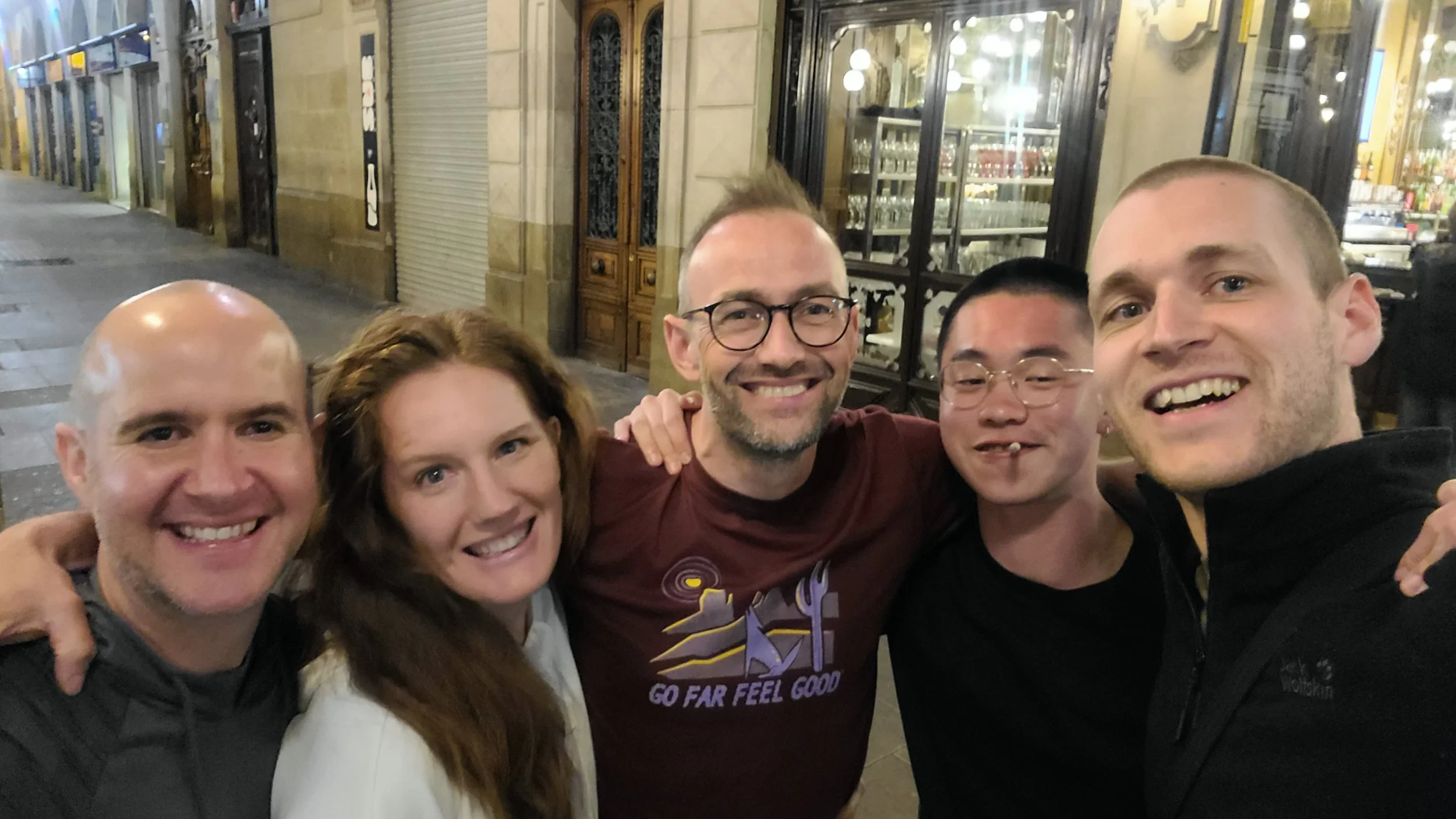 5 friends in an embrace in Pamplona with old architecture