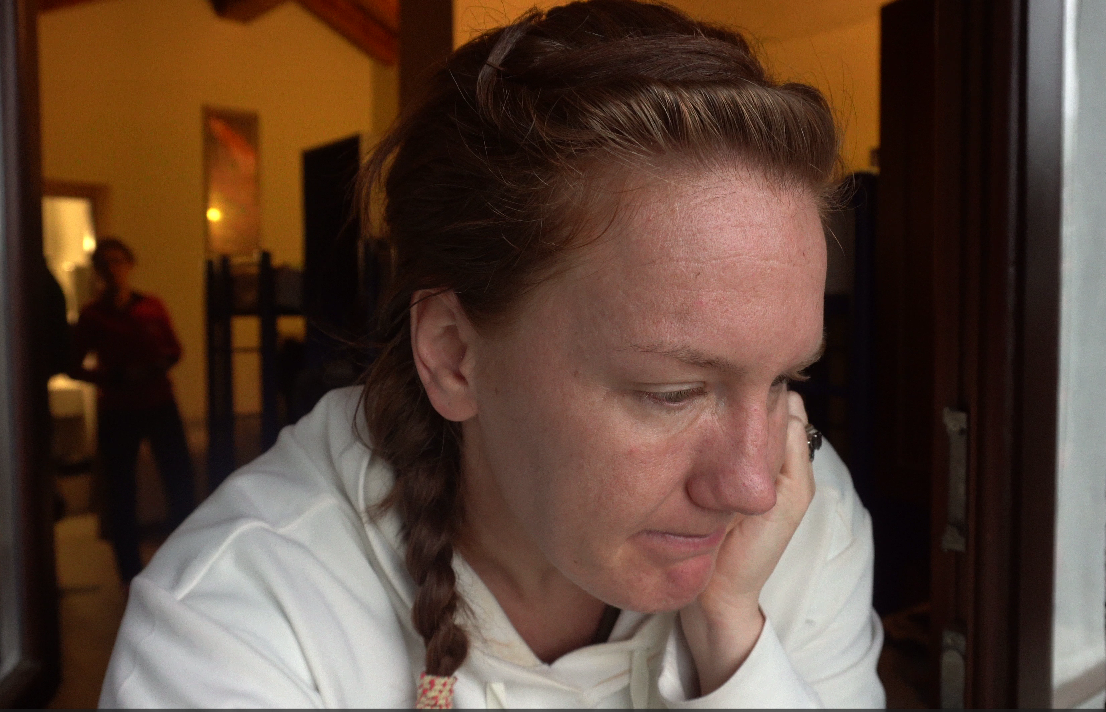 Sad woman sitting at coffee shop leaning on her hand