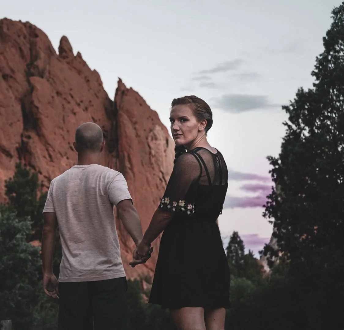 man and woman holding hands in Garden of the Gods in Colorado