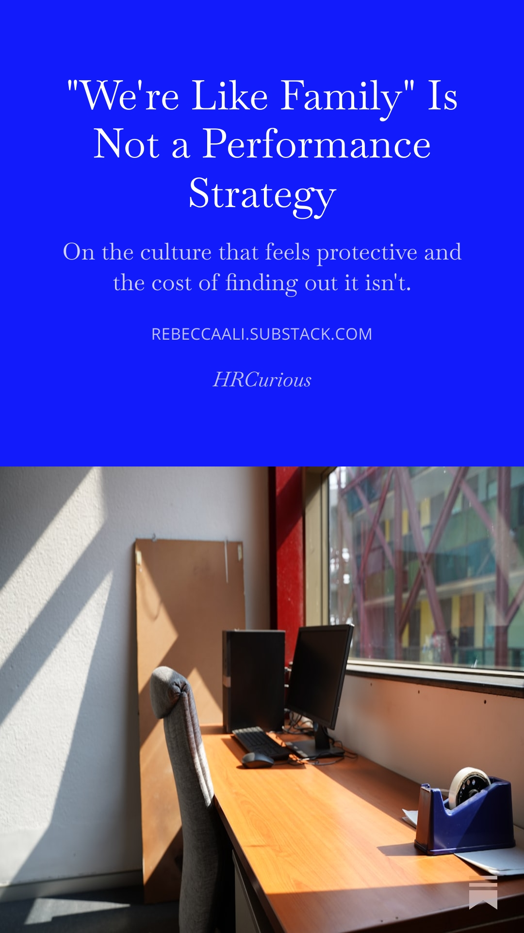 A quote about workplace culture on a blue background at the top of the image, with an office workspace showing a desk, two monitors, a chair, a tape dispenser, and a window with a view of colorful building structures outside.