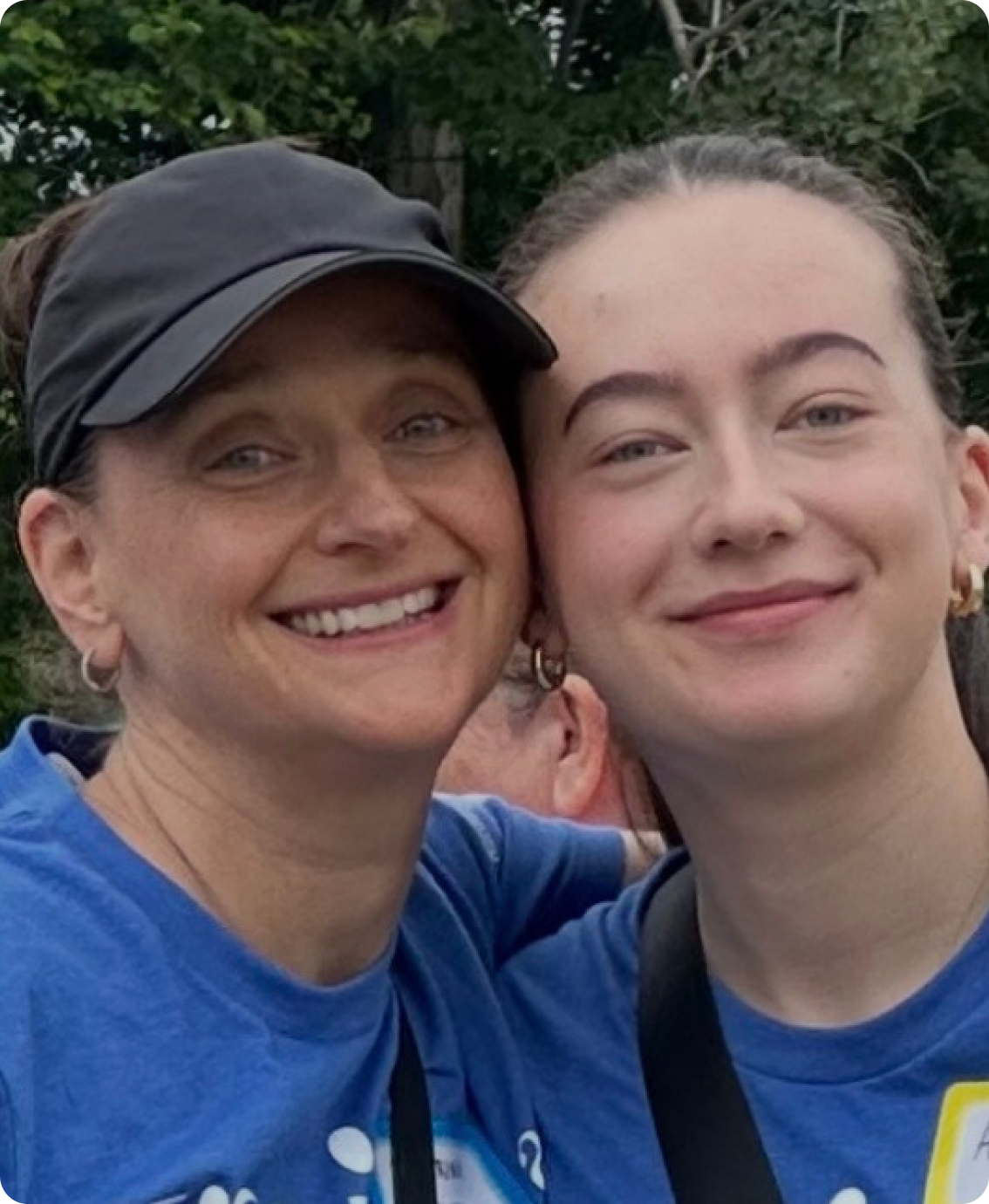 Two women smiling cheek to cheek at a walking event