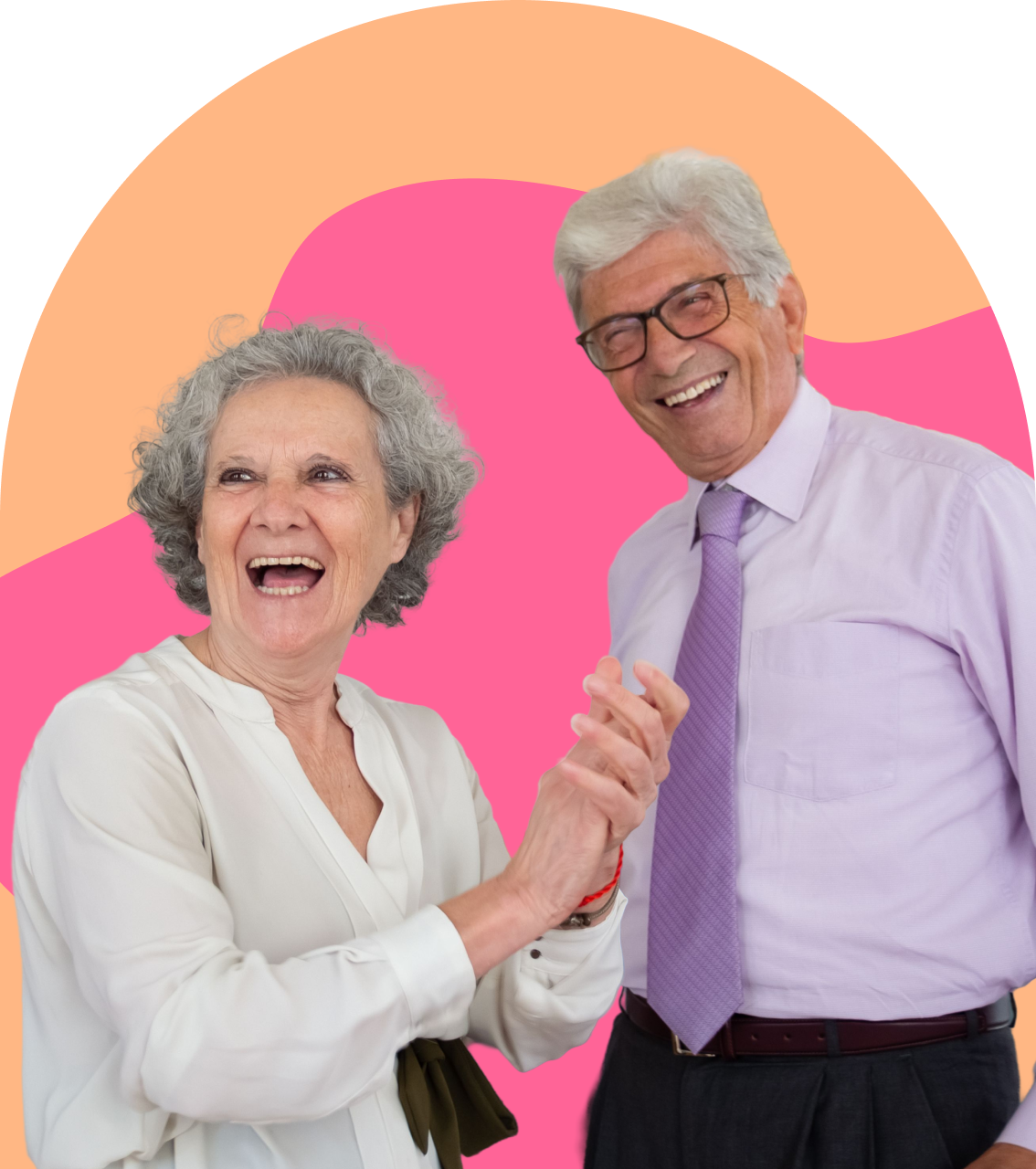 An older couple laughing and holding hands