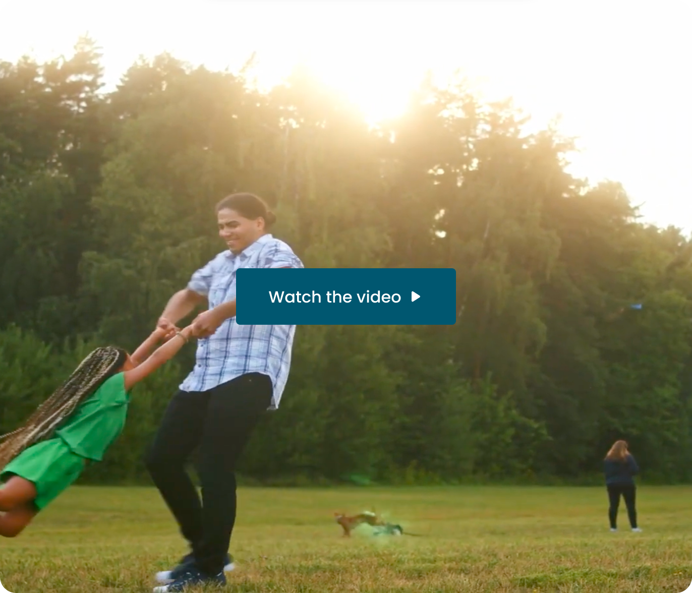A father swinging his daughter in a sunny field. Watch the video