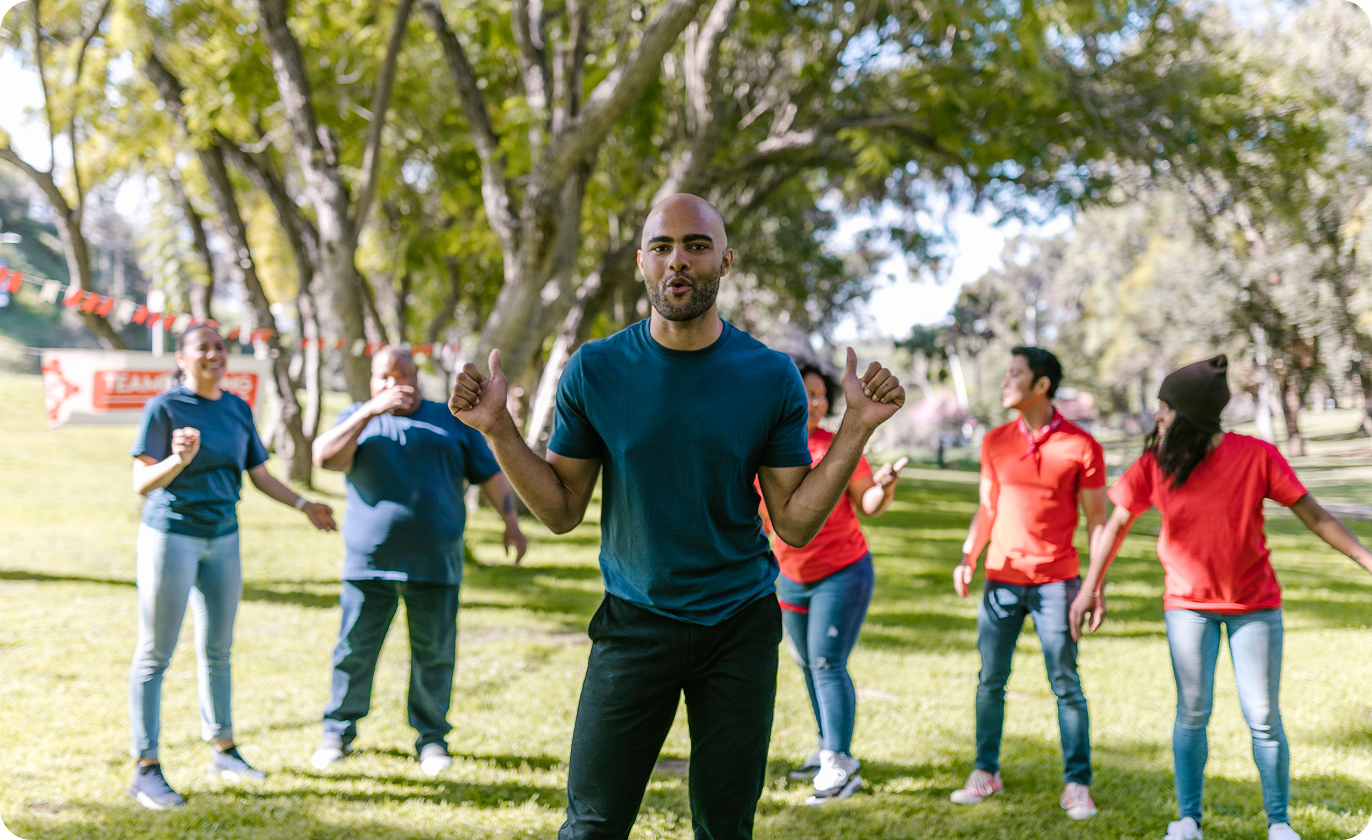 A group of people doing a movement activity together in a park