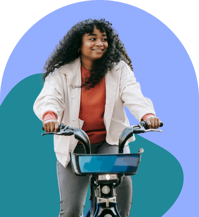 A smiling woman riding a bike
