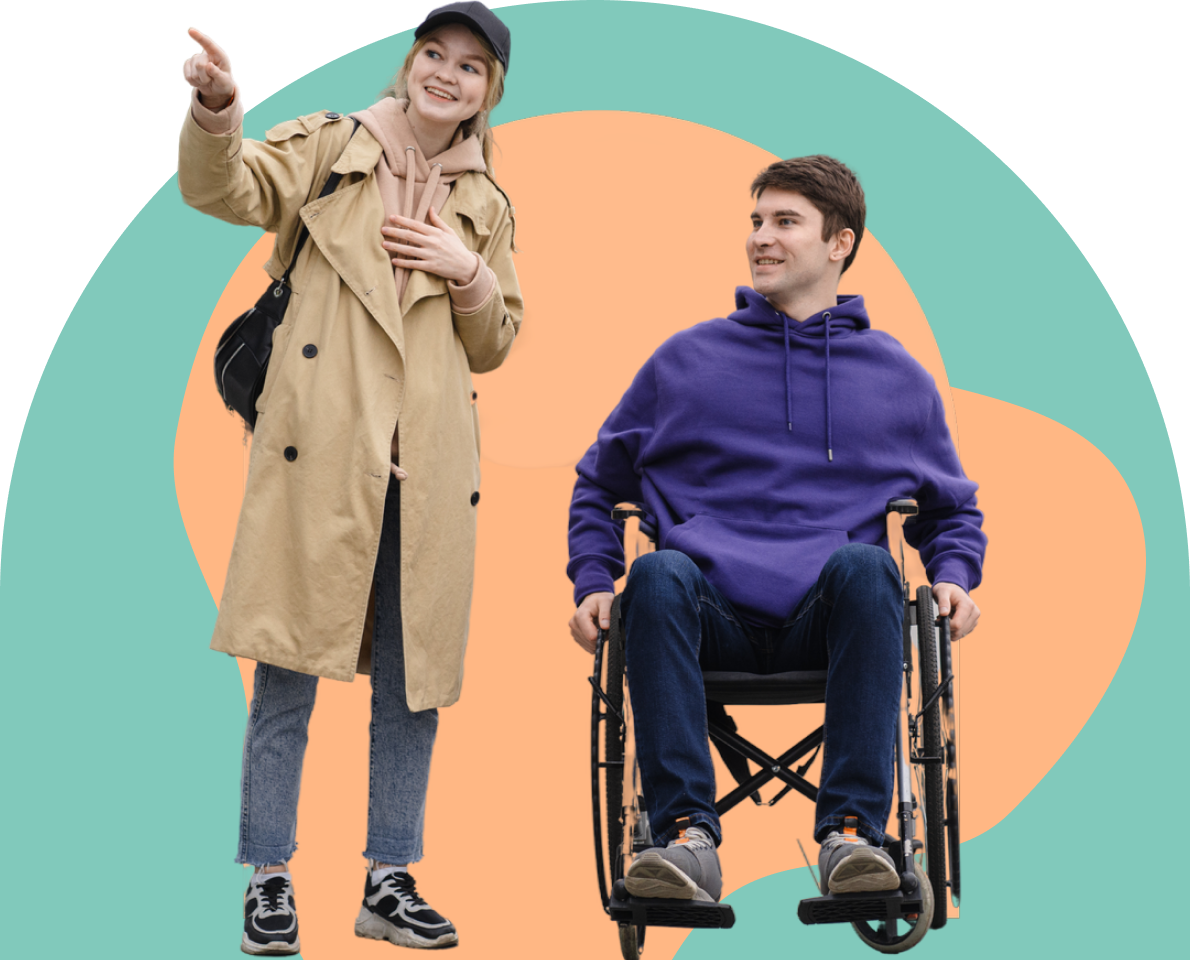 A young woman pointing ahead beside a young man using a wheelchair