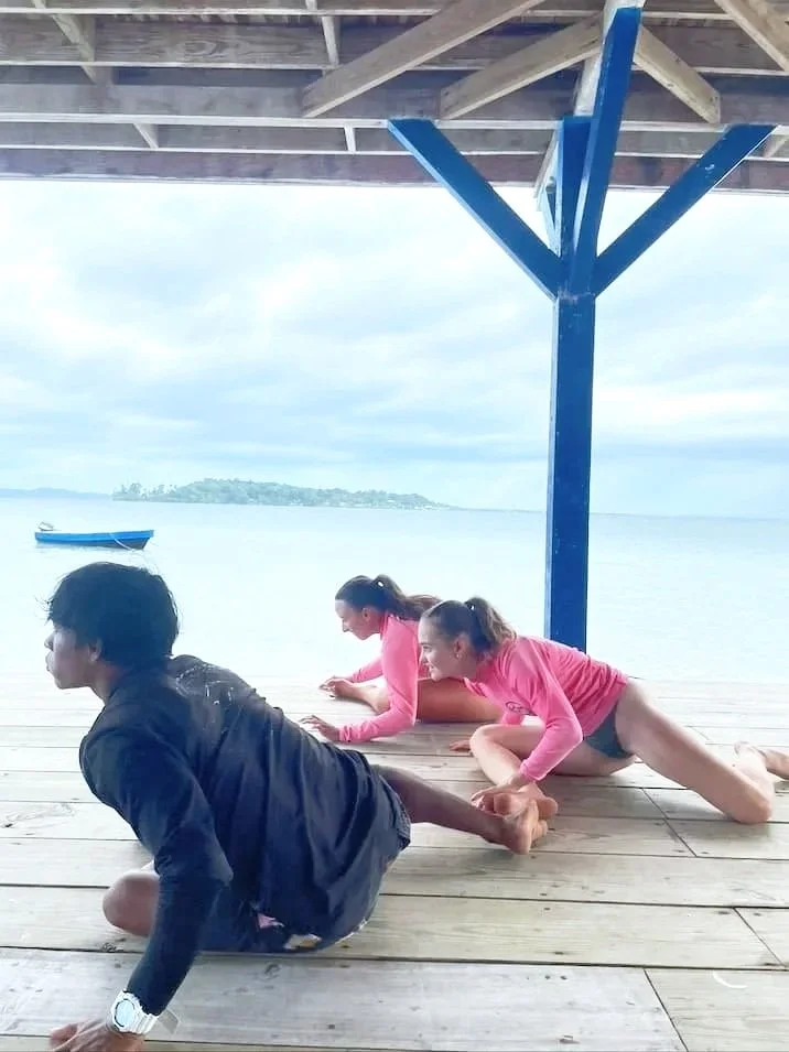 Surf instructor stretching with students at The Experience Surf Camp at Bocas del Toro Panama