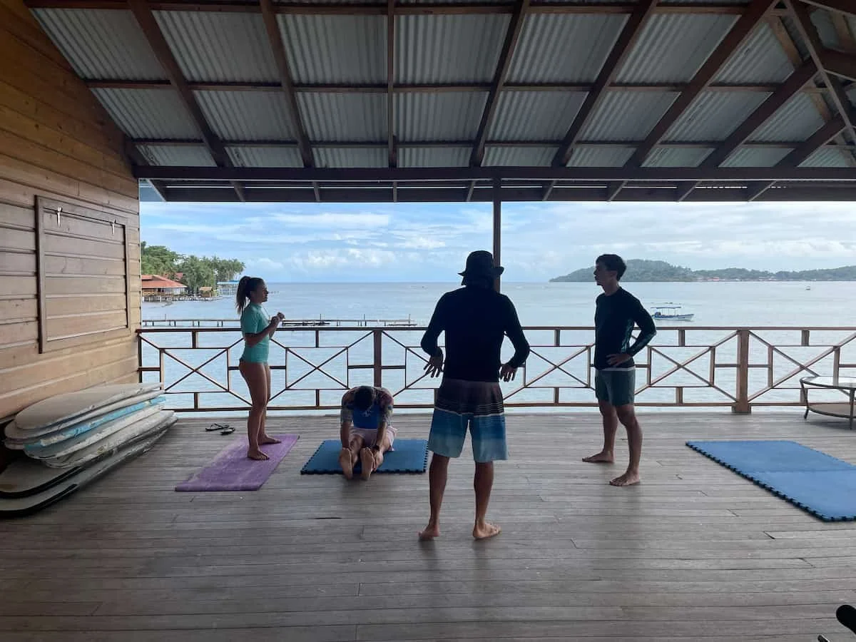 Participants of surf camp stretching and doing a surf lessons at the surf school for the experience surf camp at bocas del toro Panama