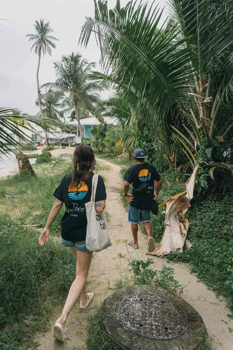 Local surf instructor and guide guiding a surfer student participant of The Experience Surf Camp around Carenero Island in bocas del toro Panama