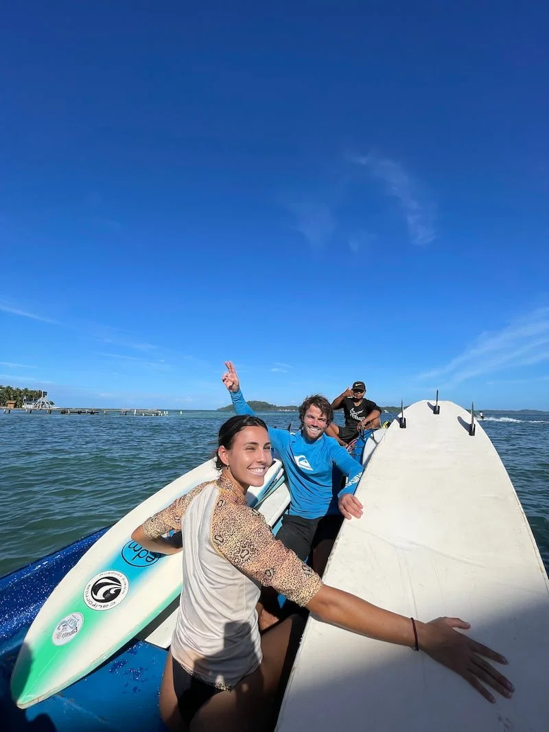 A couple of surfers enjoying their local ttransportation to go catch some waves with The Experience Surf Camp