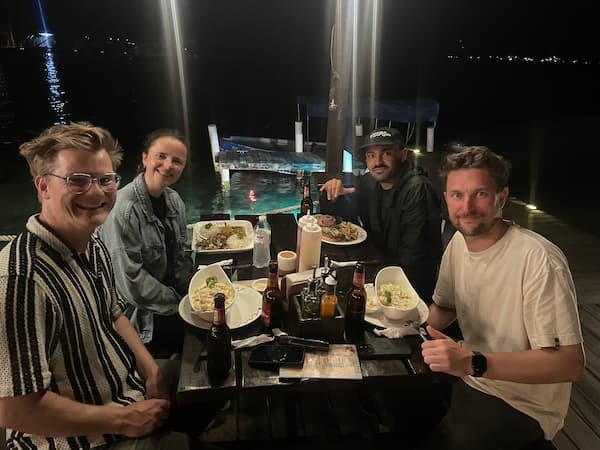 Group of friends enjoying the surf camp dinner at The Experience in Bocas del Toro