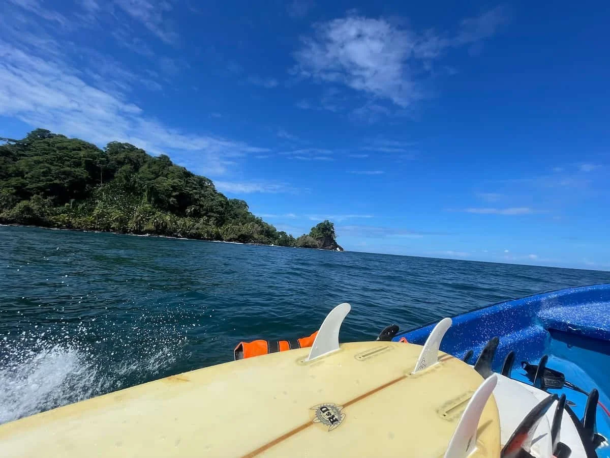 Boat with surf boards in a surf lesson in wizard beach for the experience surf camp at bocas del toro panama