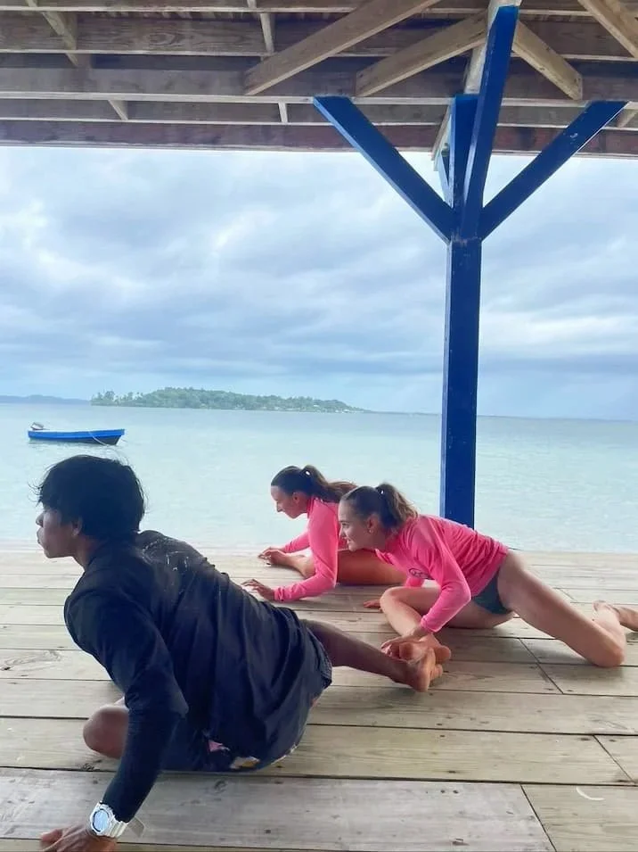 Surf instructor stretching with students at The Experience Surf Camp at Bocas del Toro Panama