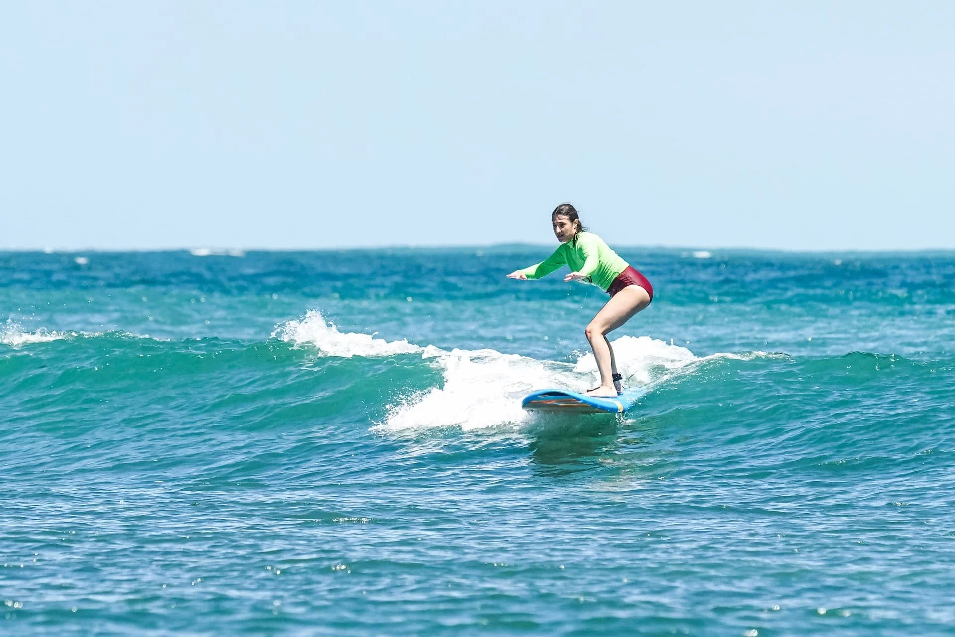 Student girl grabbing a wave during her surf lesson in bocas del toro panama surf camp 