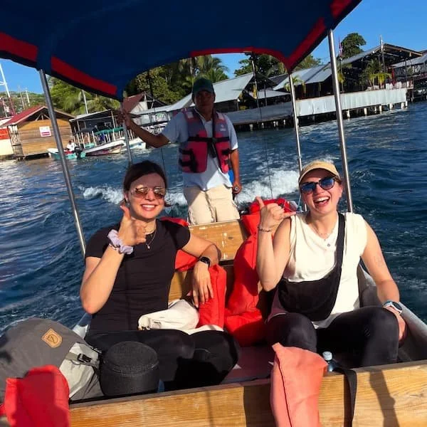 Two participants of the surf camp happy with their local transportation with the experience surf camp at bocas del toro panama