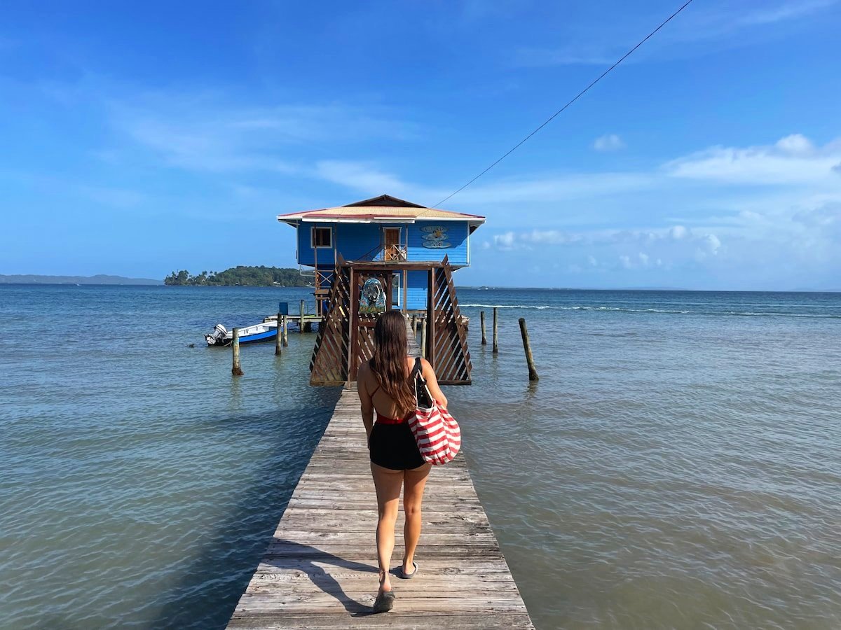 Surfer girl about to surf at the surf school with The Experience Surf Camp bocas del toro Panama