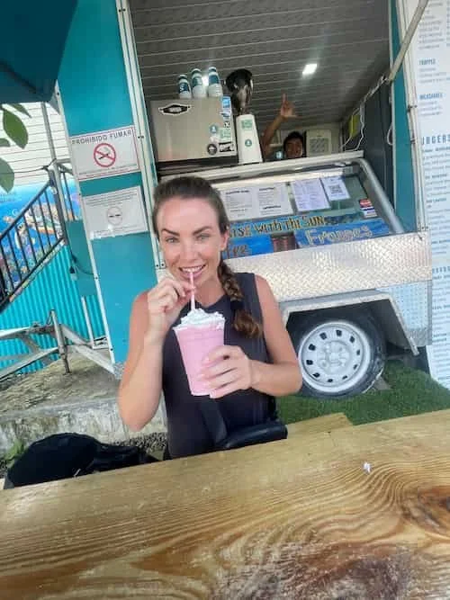 Surfer student girl enjoying an amazing milkshake during her The Experience Surf Camp at Bocas del Toro 