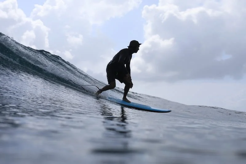 A person surfing on a wave in the ocean