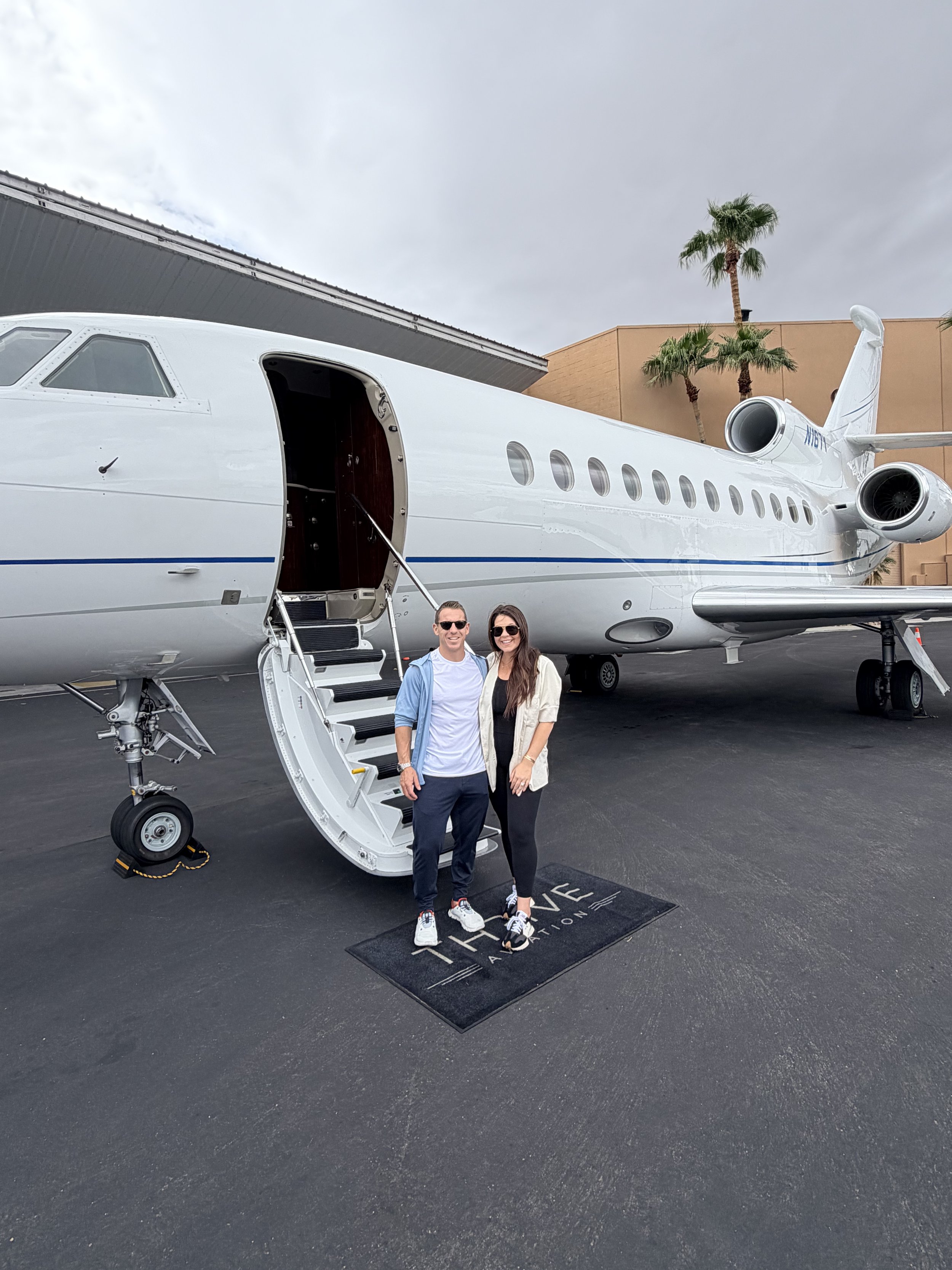 Brandon and Addie in front of a Thrive Aviation aircraft