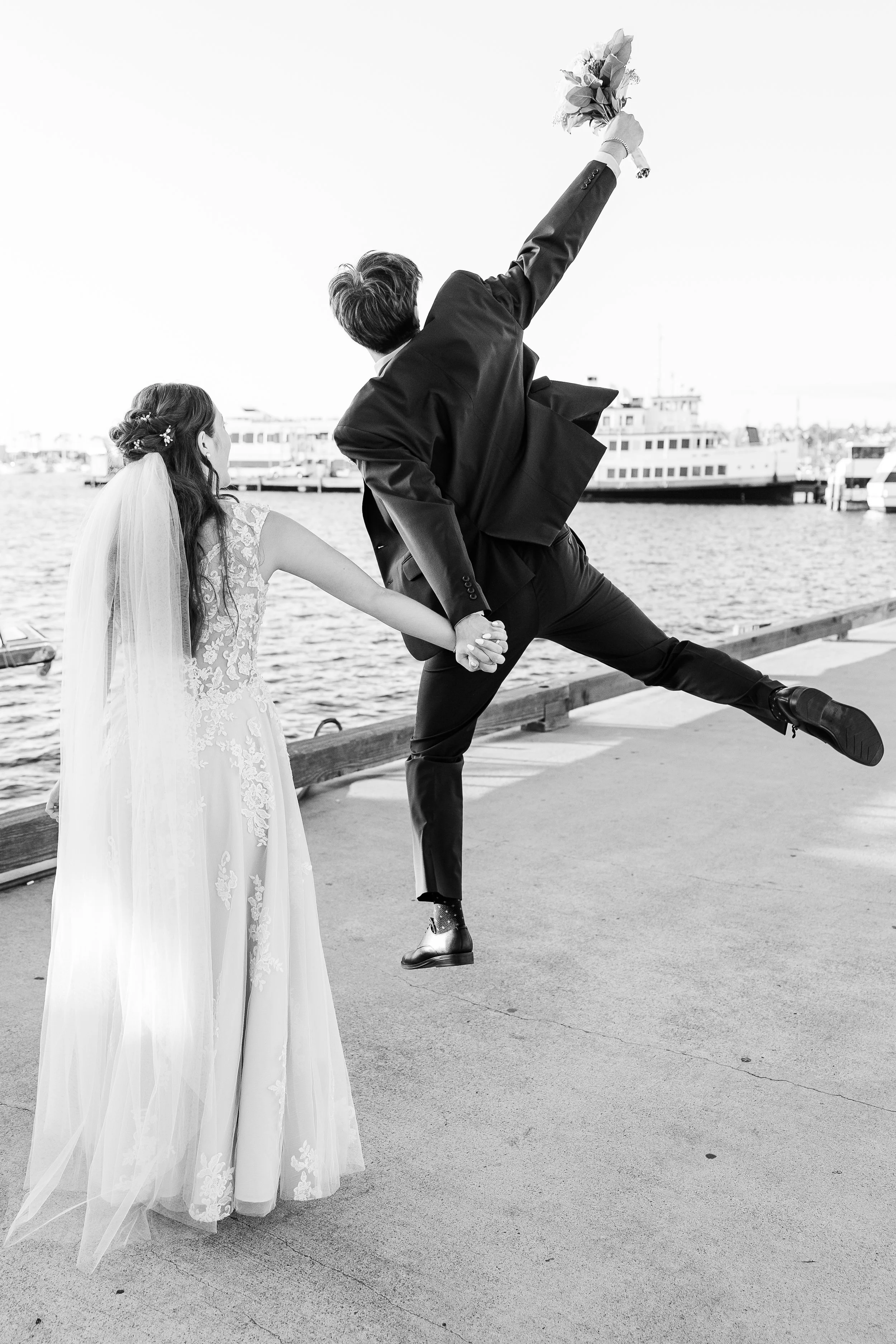 black and white groom jumping