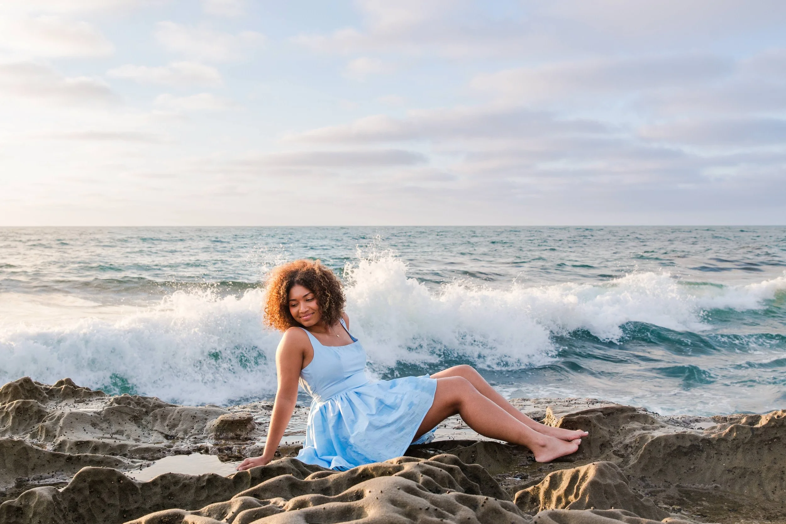 woman-sitting-ocean-splash-blue.jpeg