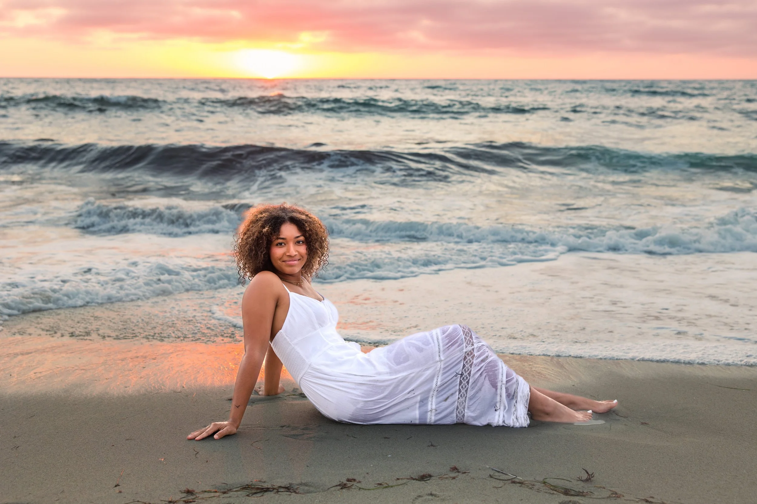 woman-sitting-sand-wet-white.jpeg