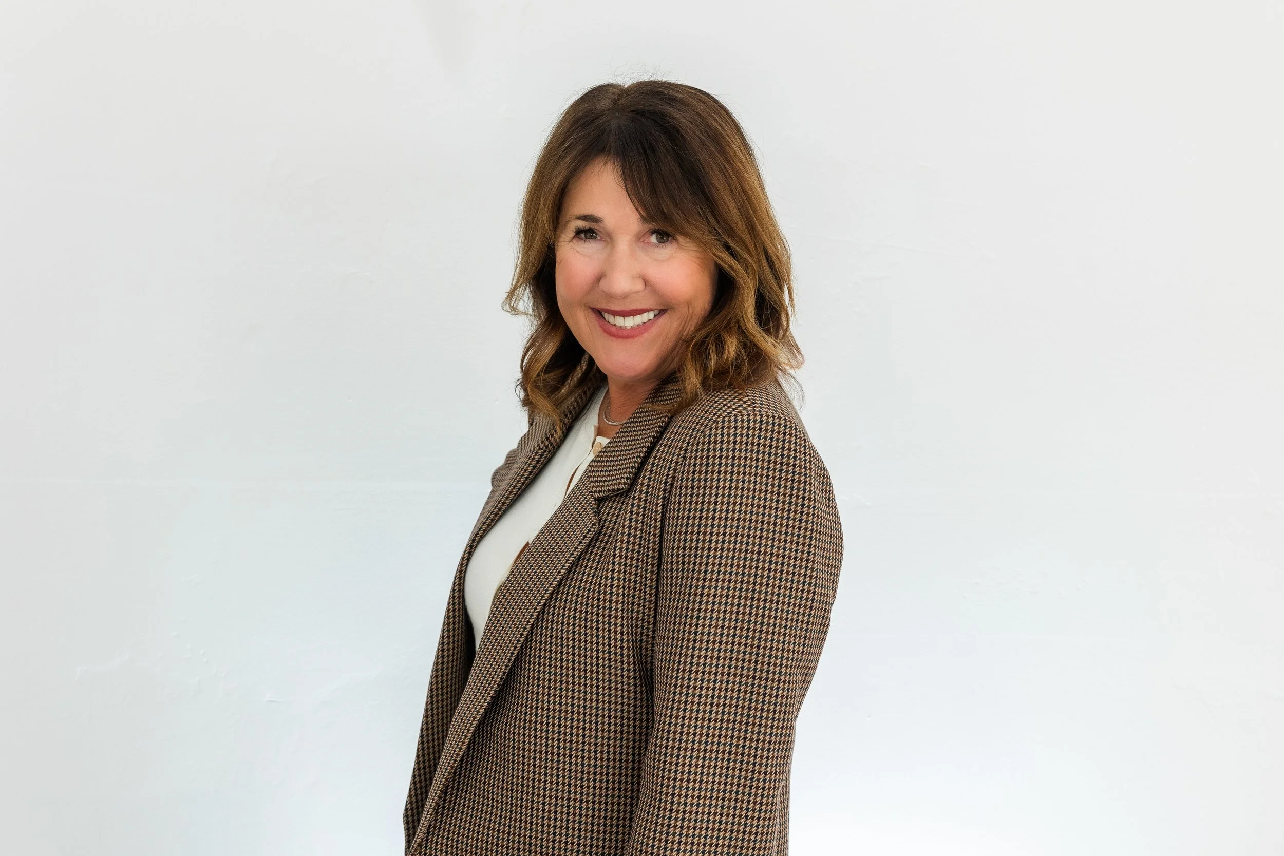 woman standing business jacket.jpg