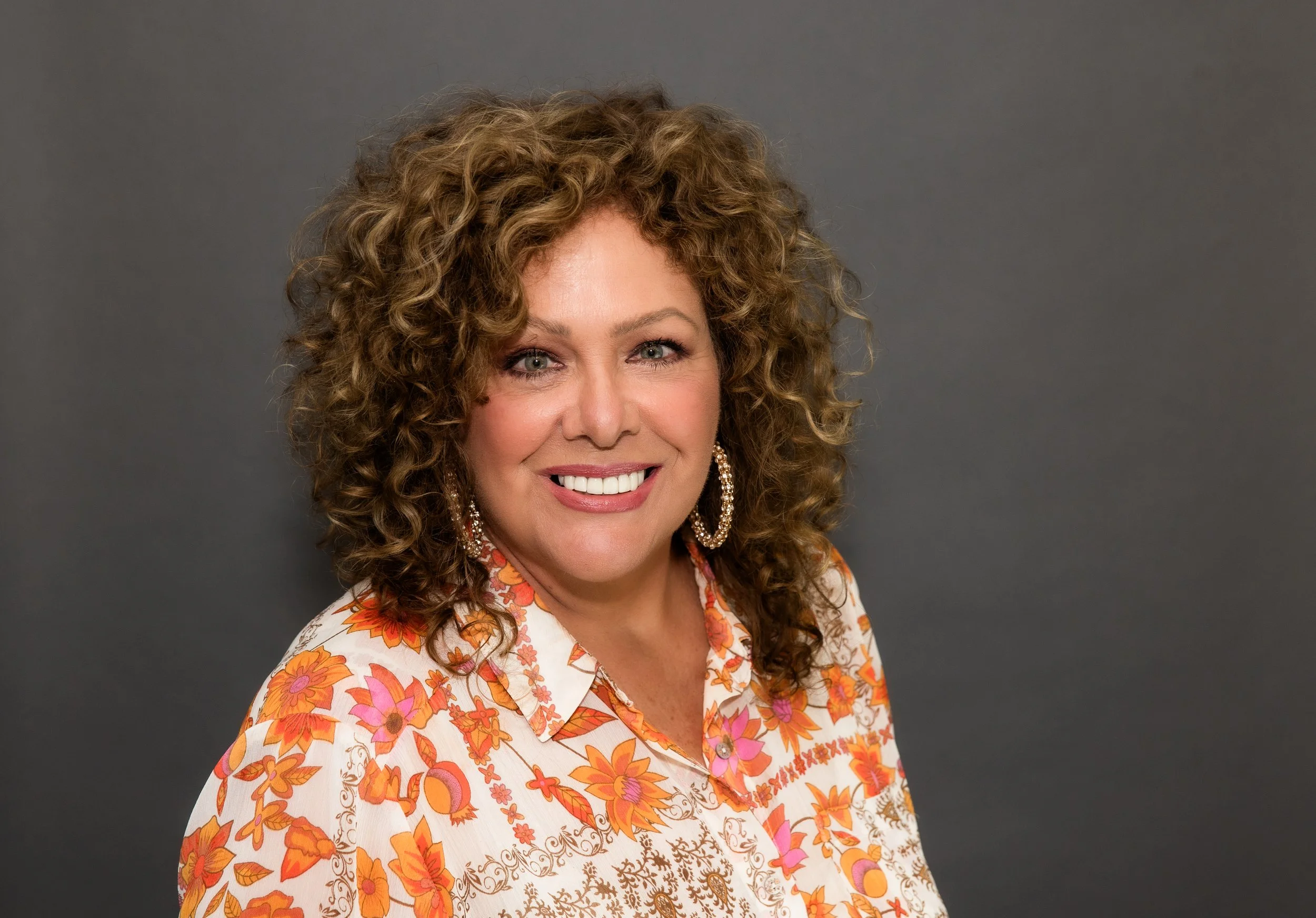 woman curly hair orange shirt.jpg