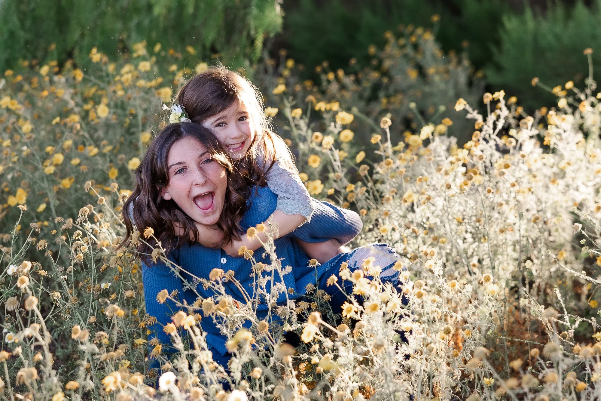 bonita-sisters-smiling-flower-field.jpg